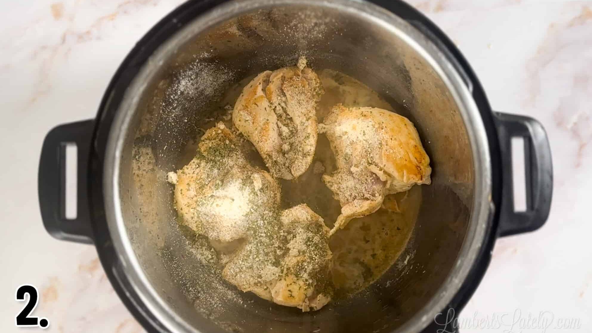 seared chicken topped with spices in an instant pot.