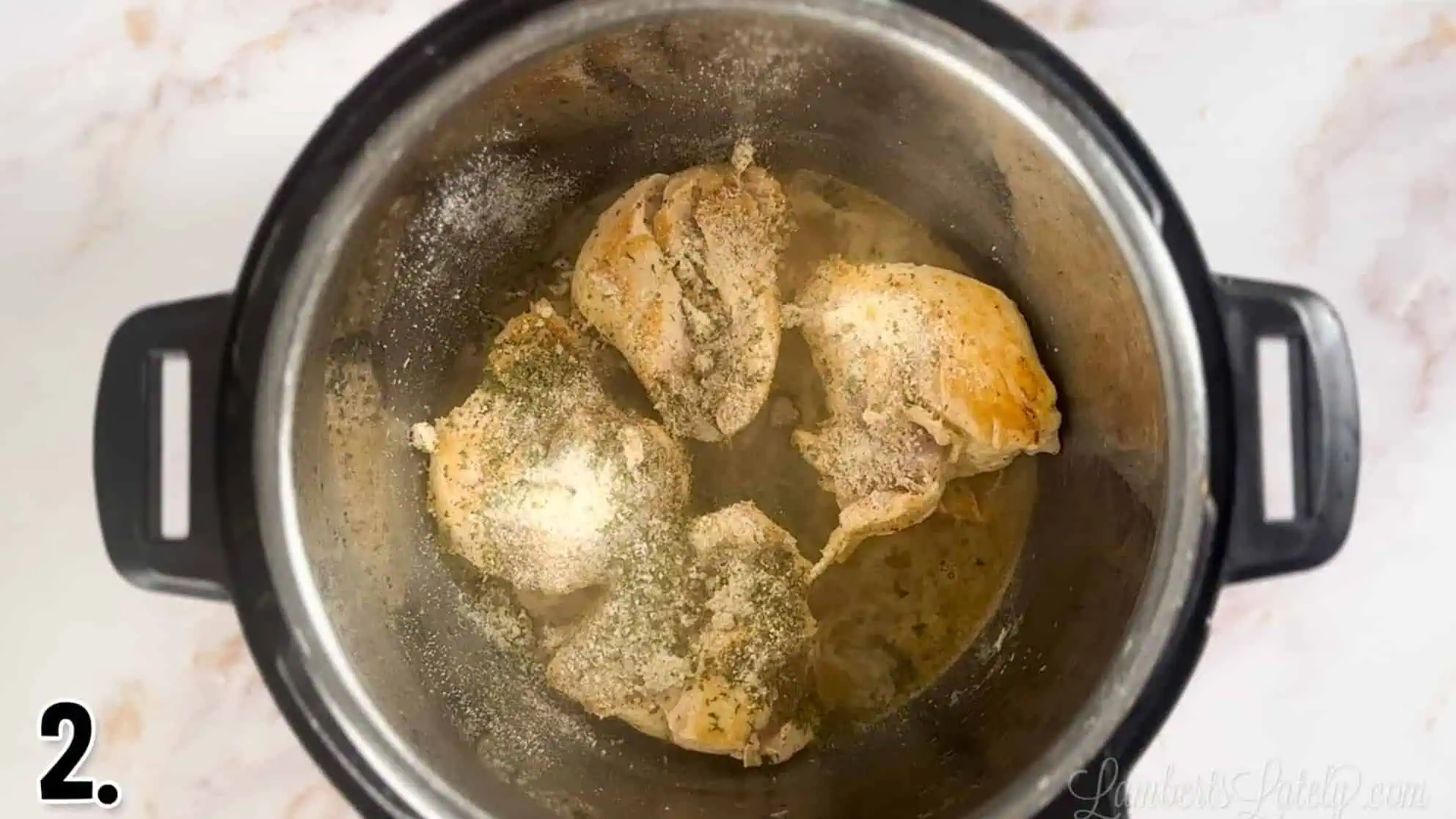 seared chicken topped with spices in an instant pot.