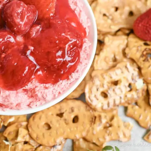 strawberry pretzel dip in a ramekin, covered in strawberry pie filling.