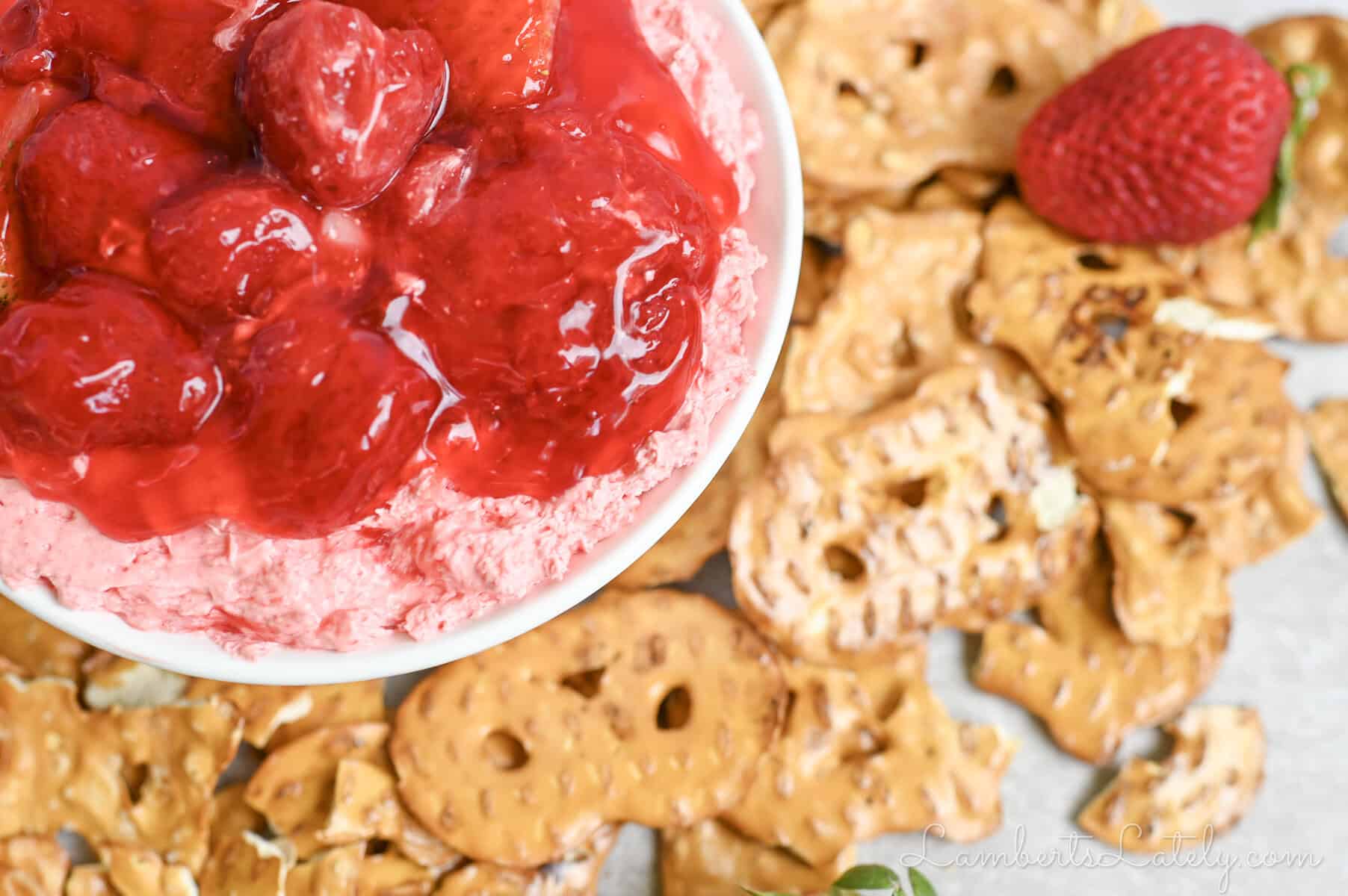strawberry pretzel dip in a ramekin, covered in strawberry pie filling.