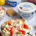 Strawberry banana cheesecake salad with no-bake cheesecake mix and fresh fruit.