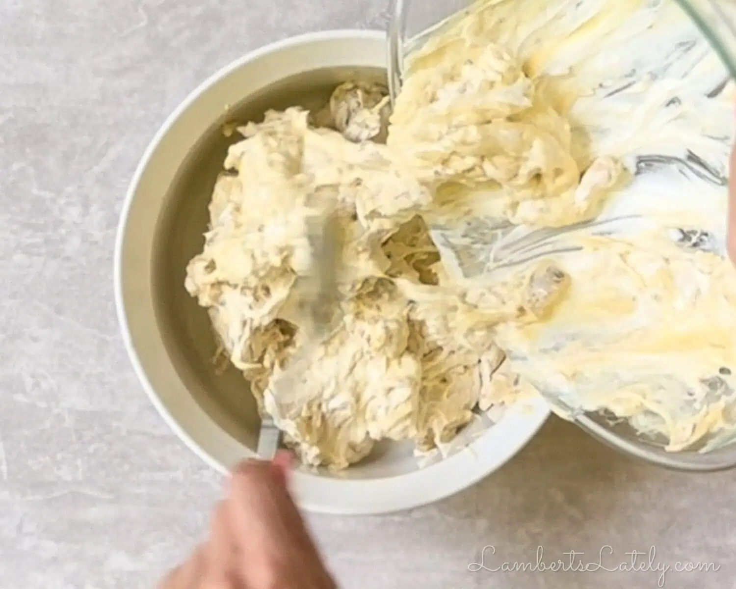 pouring the chicken mixture into a baking dish.