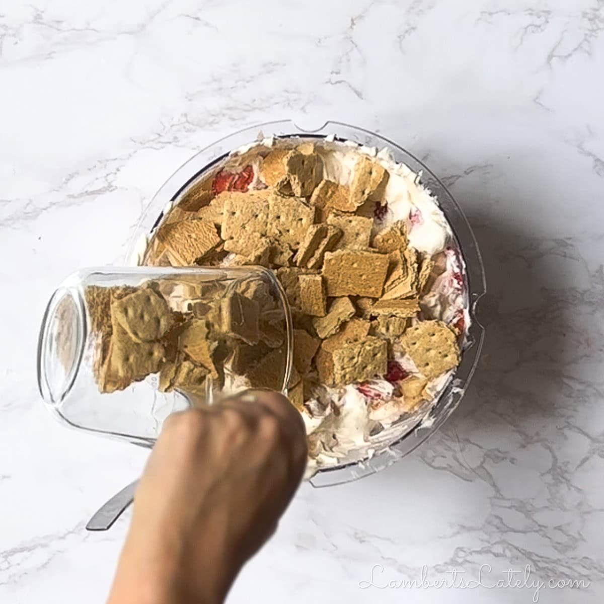 adding crushed graham crackers to the salad mixture.