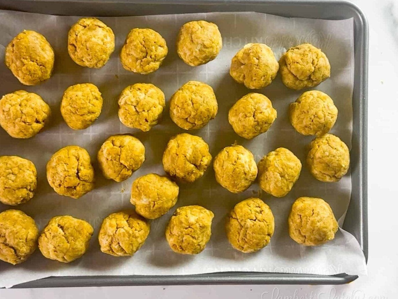cake balls on a metal pan.