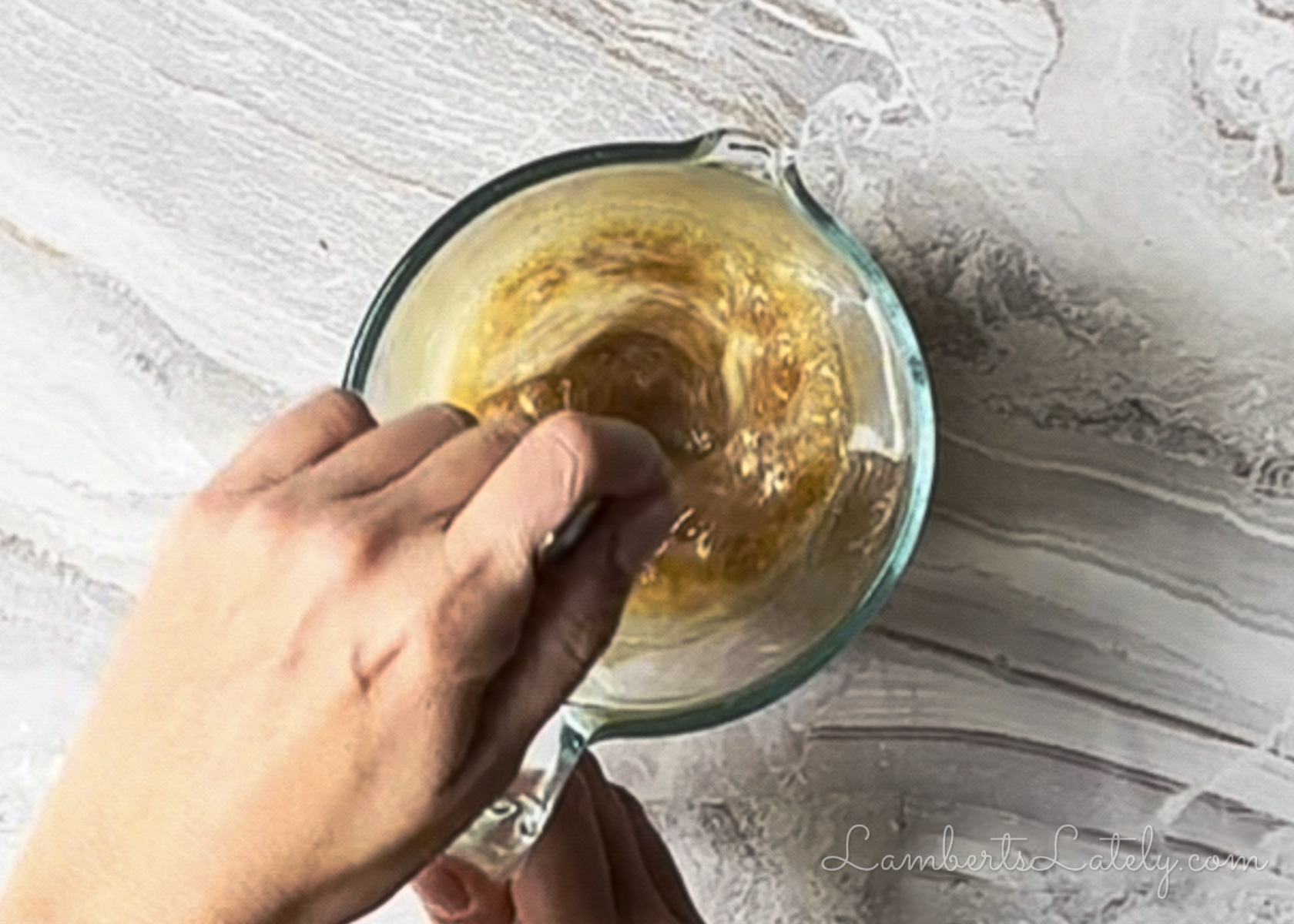 mixing butter, brown sugar, and garlic powder in a measuring cup.