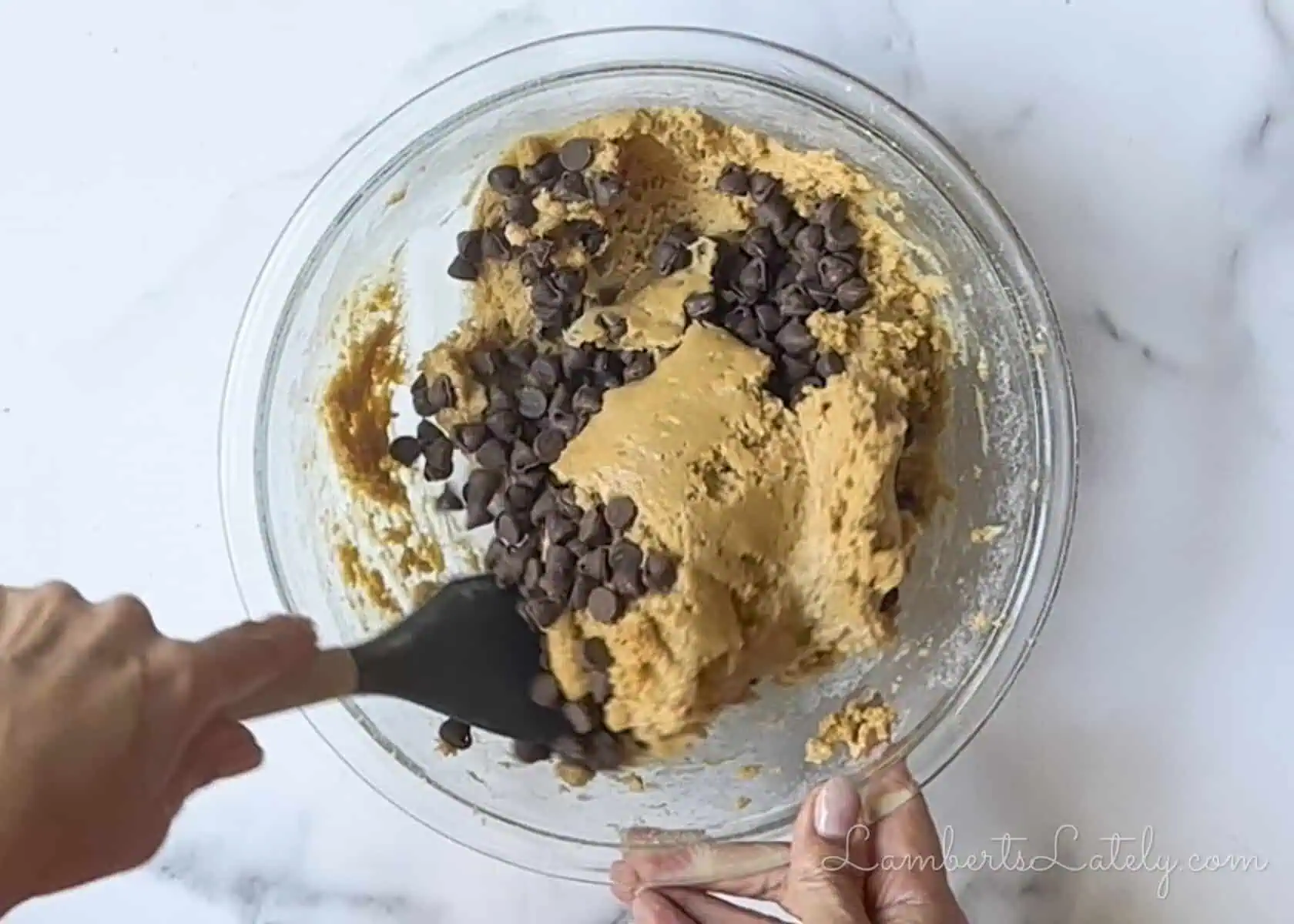 folding chocolate chips into the peanut butter cookie dough.