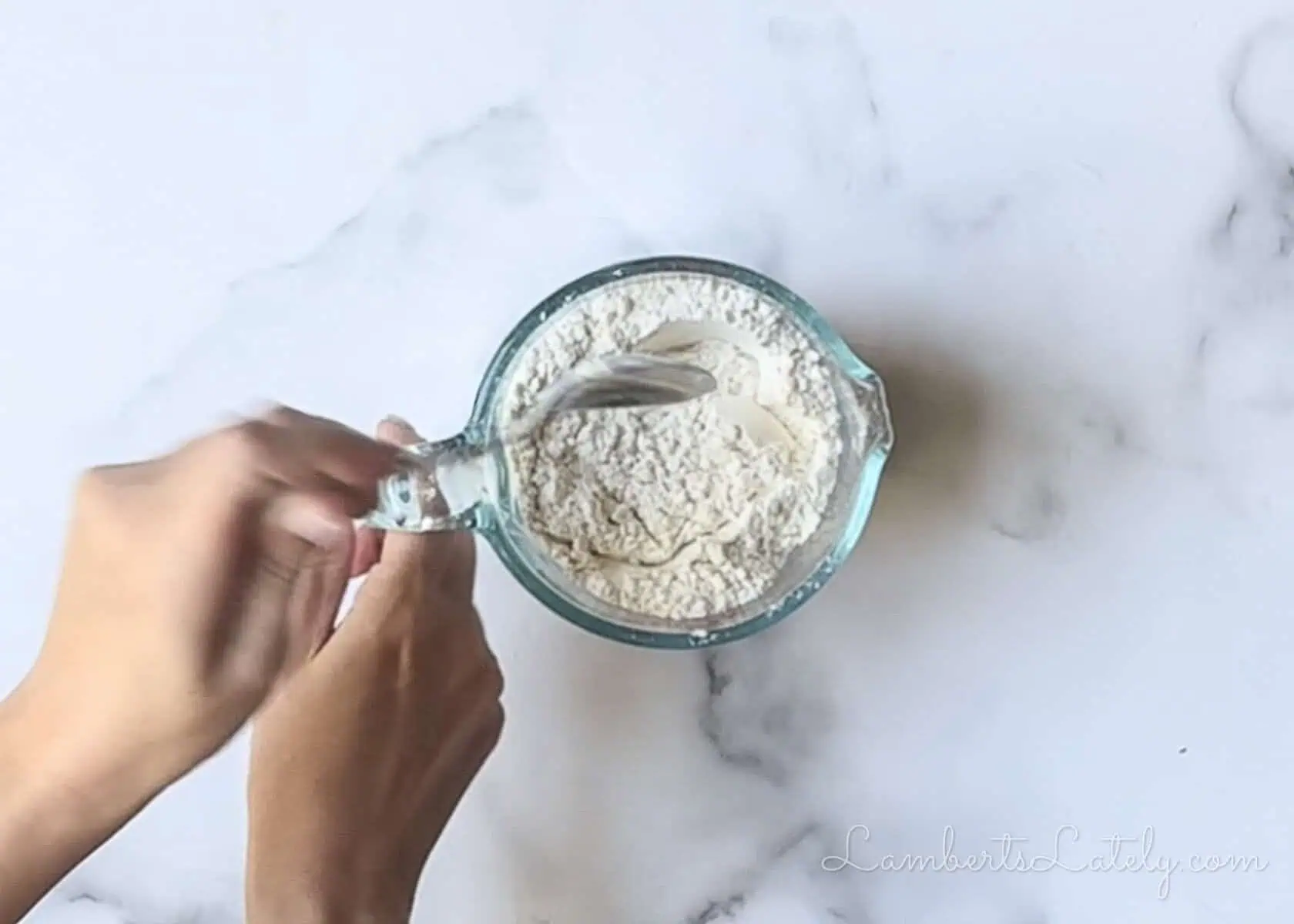 stirring dry ingredients in a measuring cup.