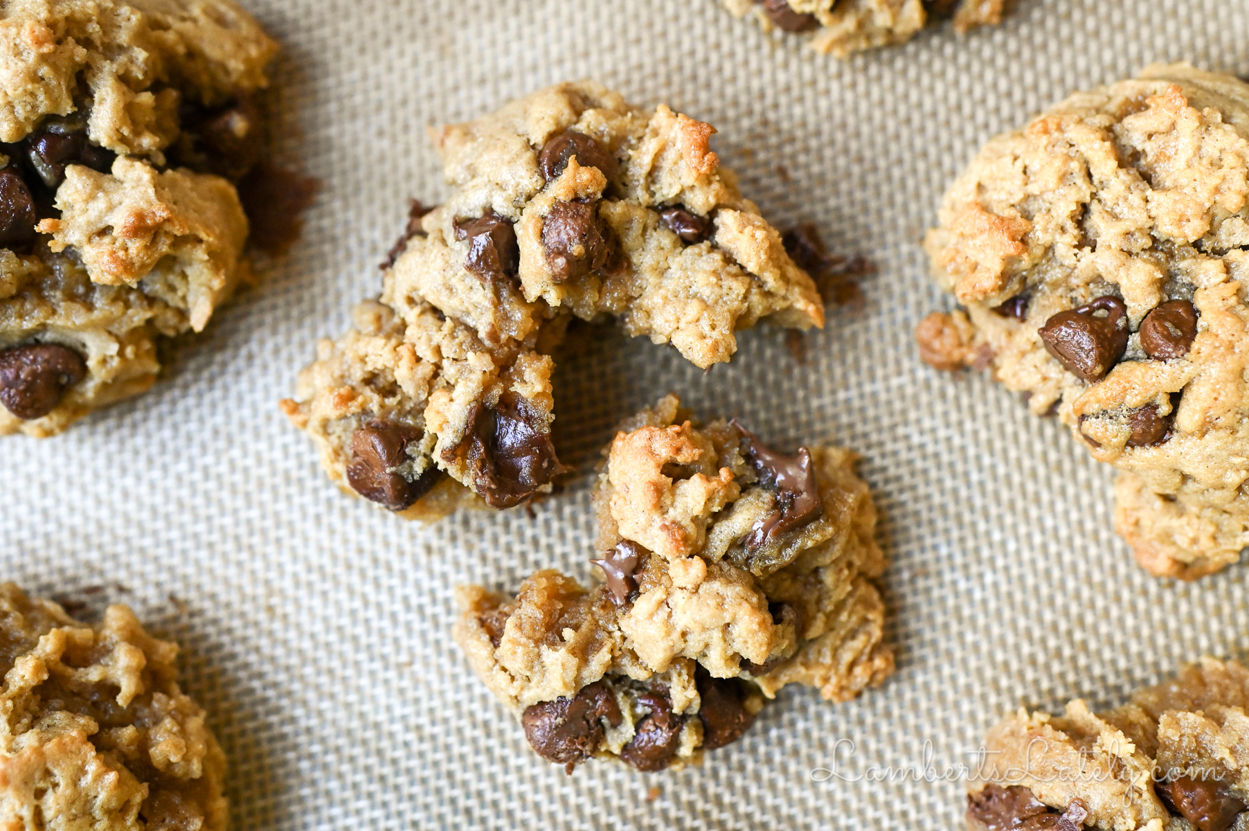 peanut butter chocolate chip cookie torn apart on a baking sheet.