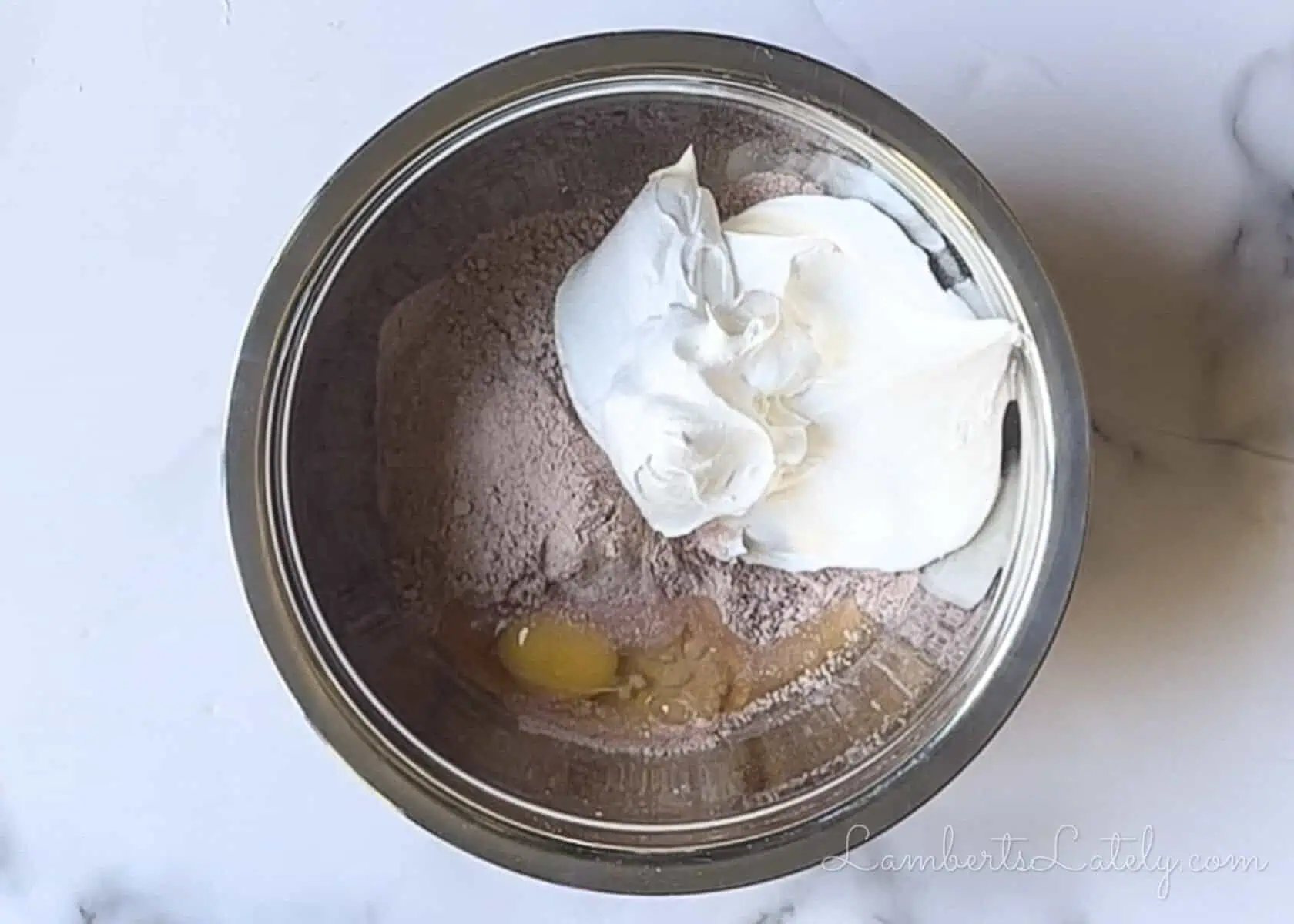 egg, cool whip, and red velvet cake mix combined in a bowl.