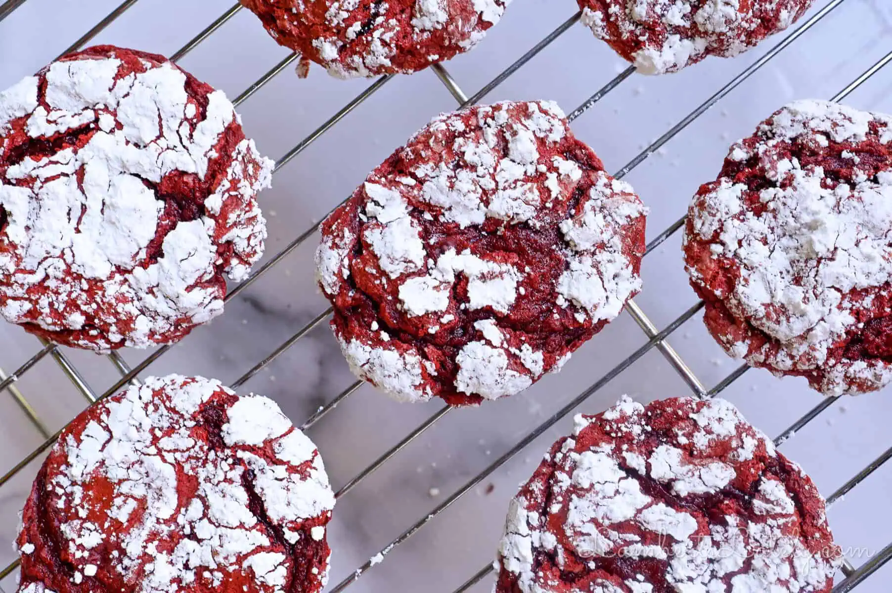 red velvet cool whip cookies cooling on a baking rack.
