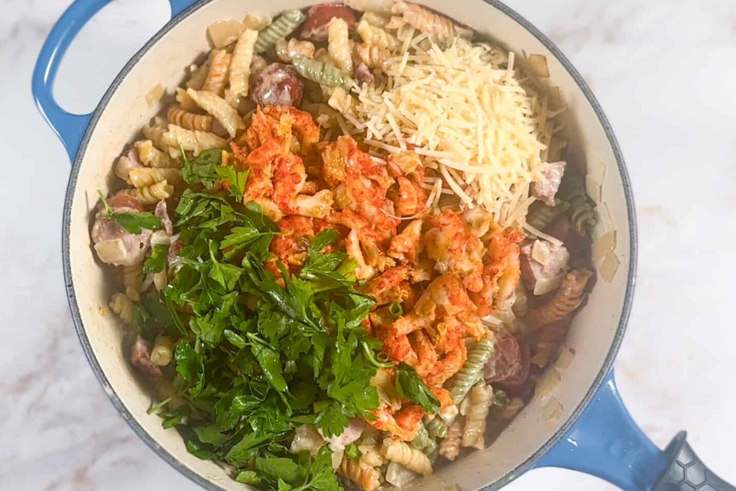 parsley, cheese, crawfish tails added to the pot of pasta.