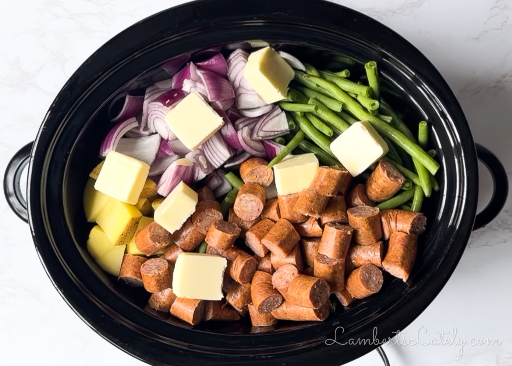 added butter to the sausage and veggies in the crockpot.