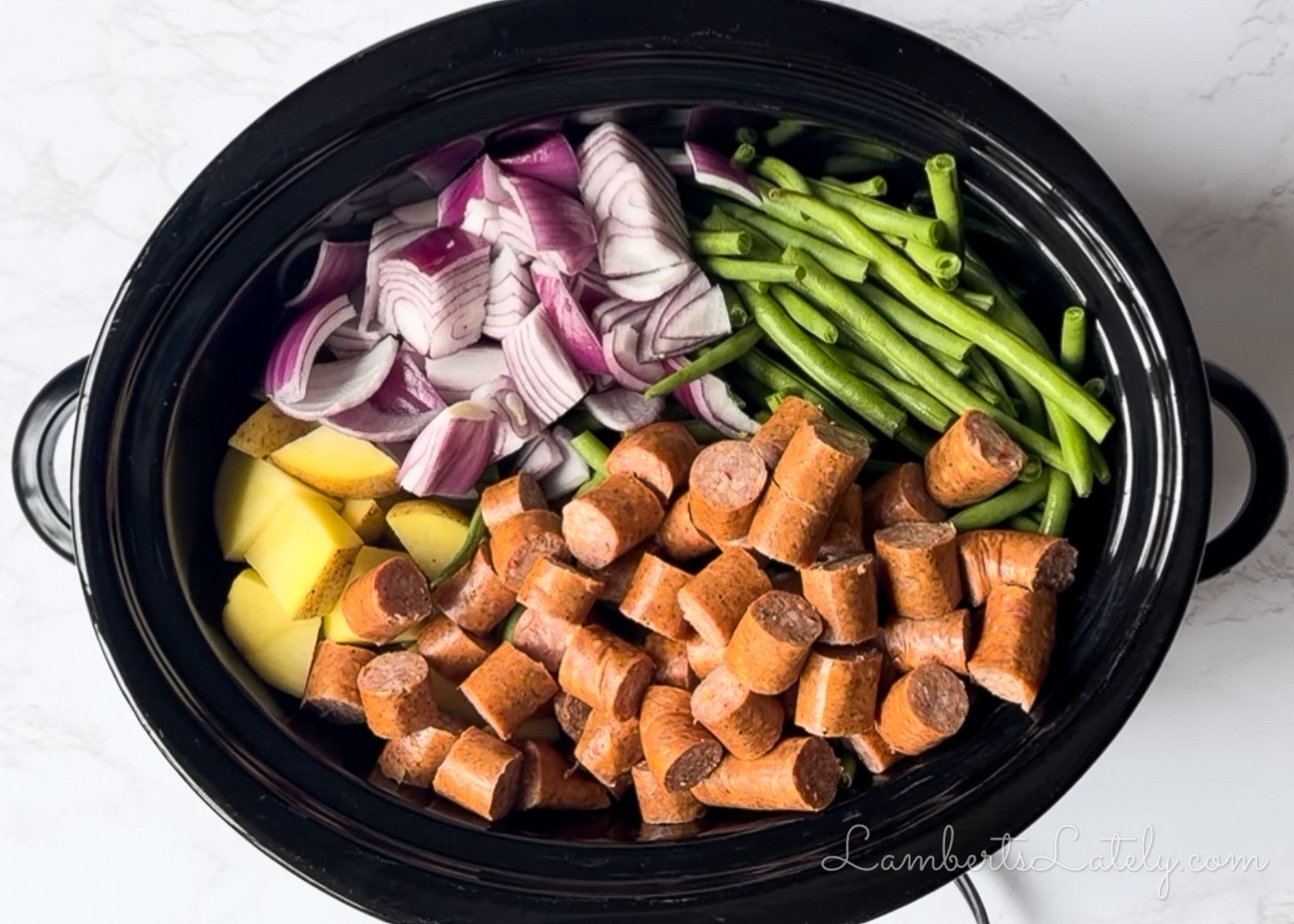 added sausage to the vegetables in the crock pot.