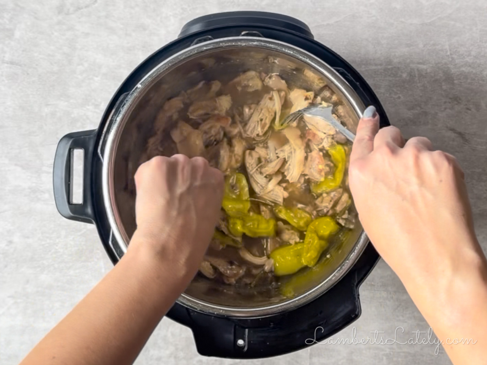 shredding the chicken with two forks, in instant pot, after cooking.