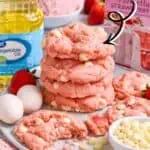 Close-up of strawberry cake mix cookies with fresh strawberries and baking ingredients.