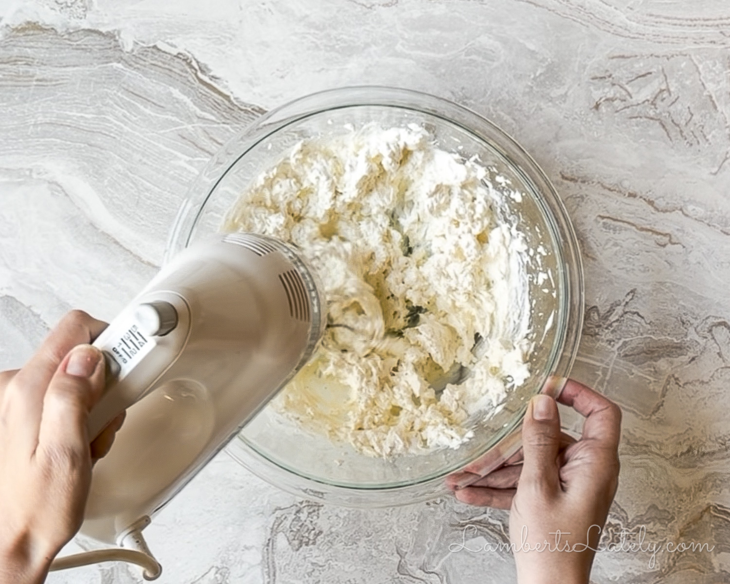 making the base for crack dip; blending ranch, cream cheese, and sour cream in a bowl.