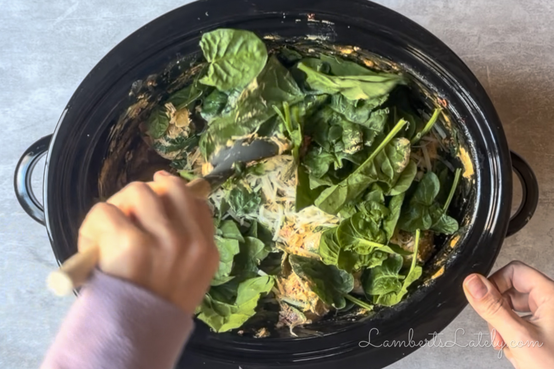 stirring spinach, basil, parmesan cheese into the creamy meatball mixture.