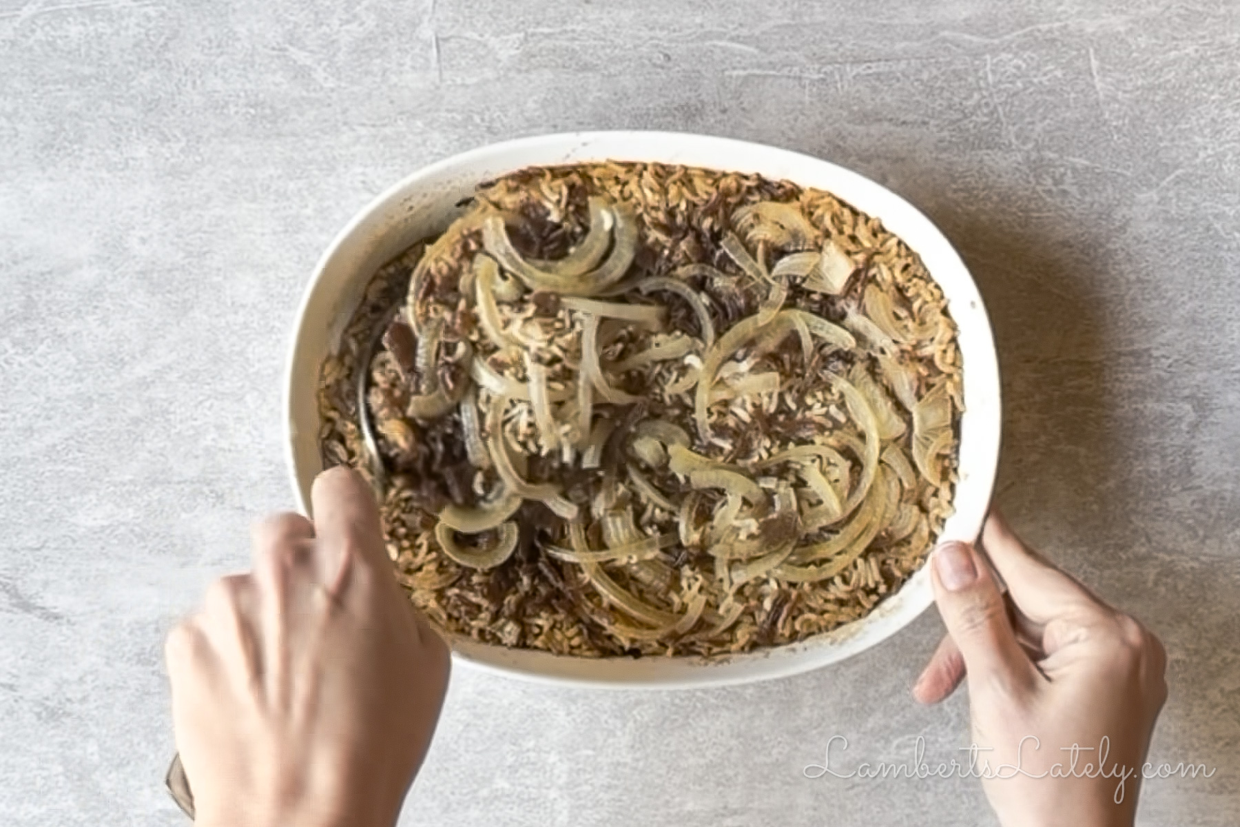 stirring the cooked french onion rice together.