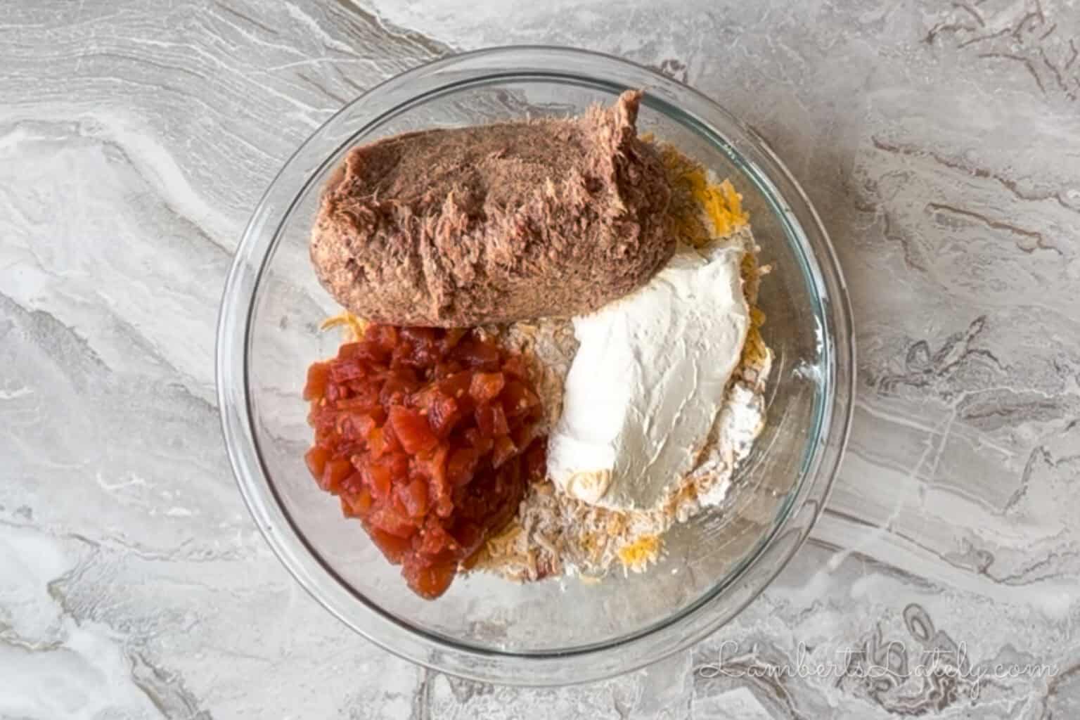sausage, drained rotel, and cream cheese added to the bisquick and cheddar mixture.