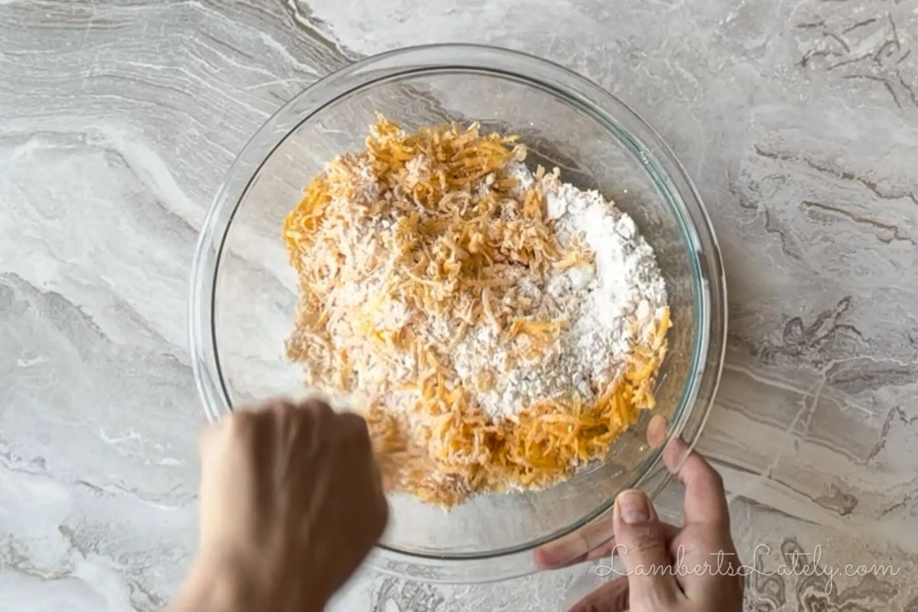 mixing cheddar cheese and bisquick in a large bowl.