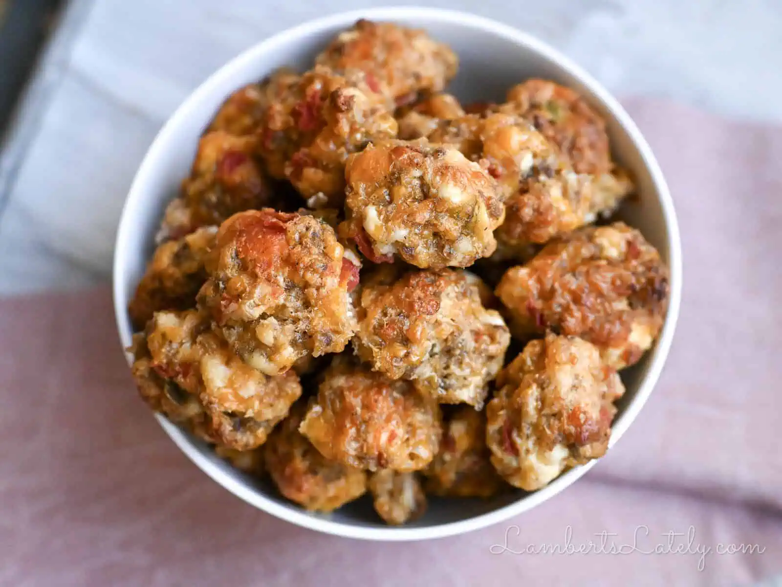 rotel cream cheese sausage balls in a bowl, next to a napkin.
