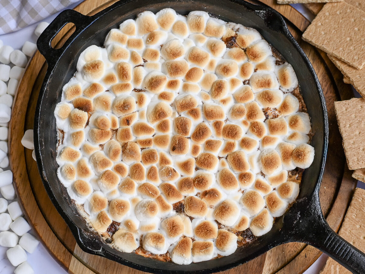 s'mores dip, with golden marshmallows, in a skillet.