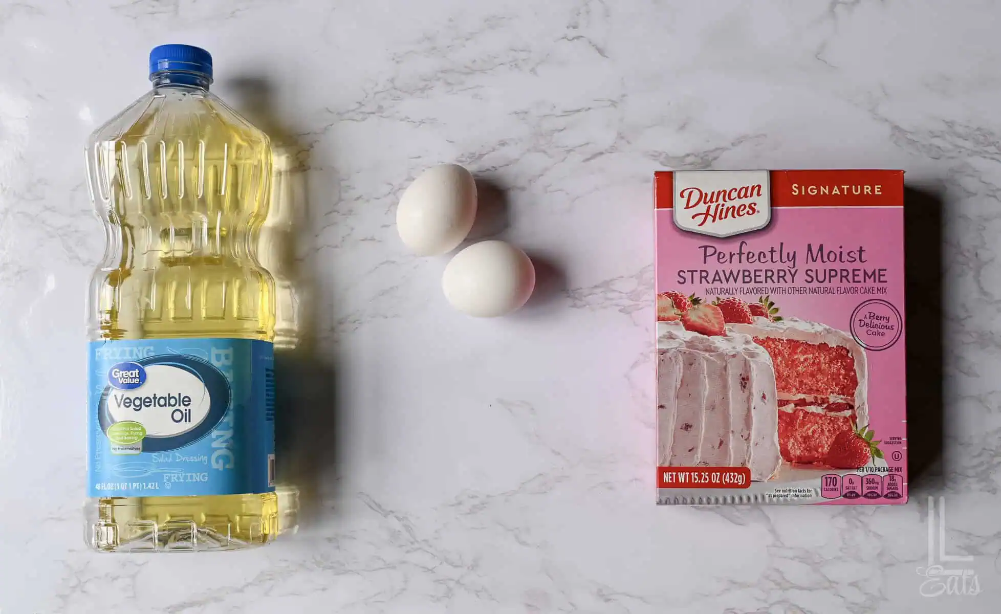 ingredients for strawberry cake mix cookies: vegetable oil, eggs, and cake mix.
