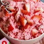 Close-up of strawberry fluff salad with strawberries and marshmallows in a bowl.