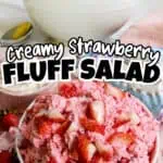 Creamy strawberry fluff salad with fresh strawberries and whipped topping in bowls.