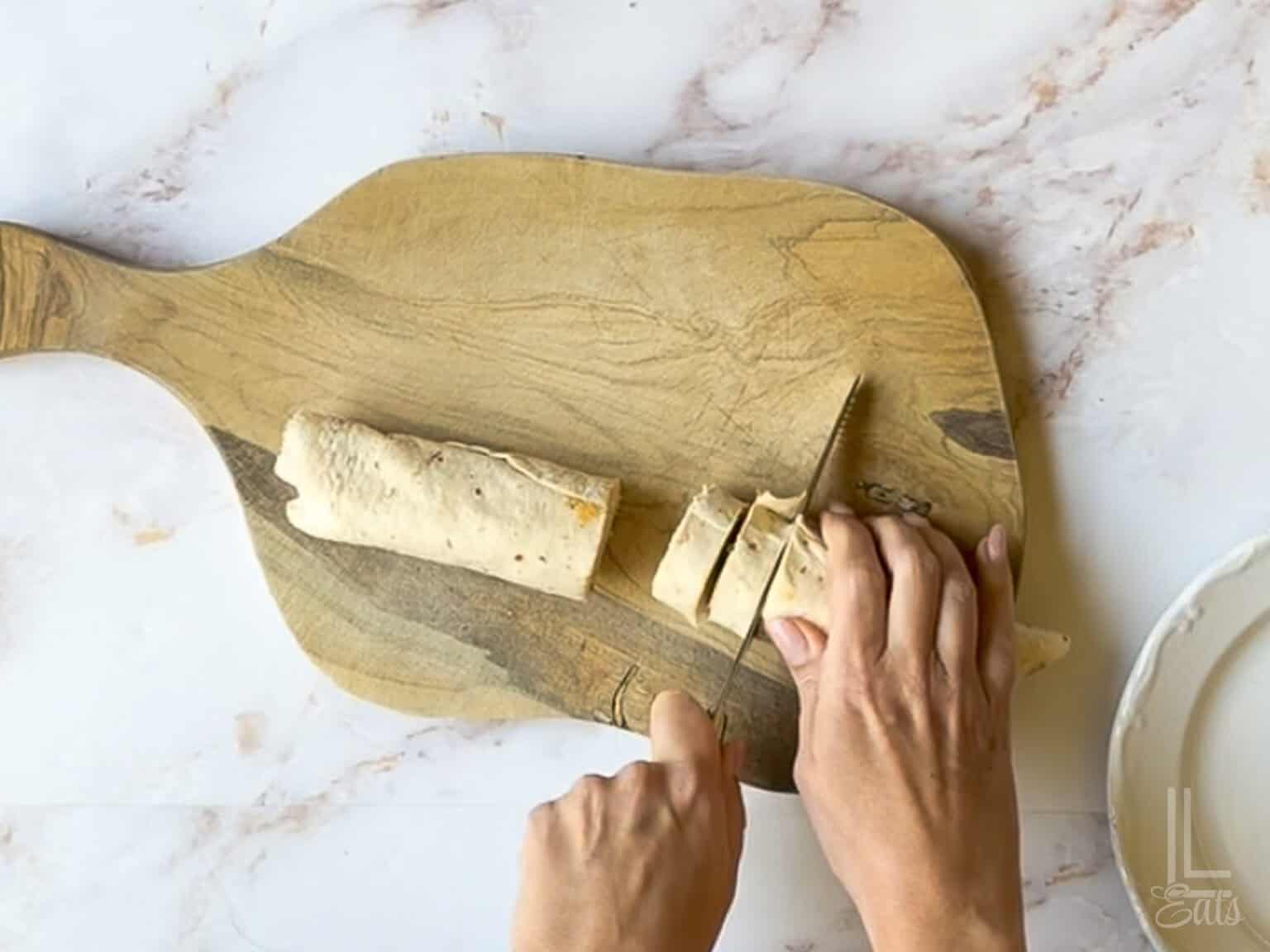 cutting unwrapped tortilla with a knife.