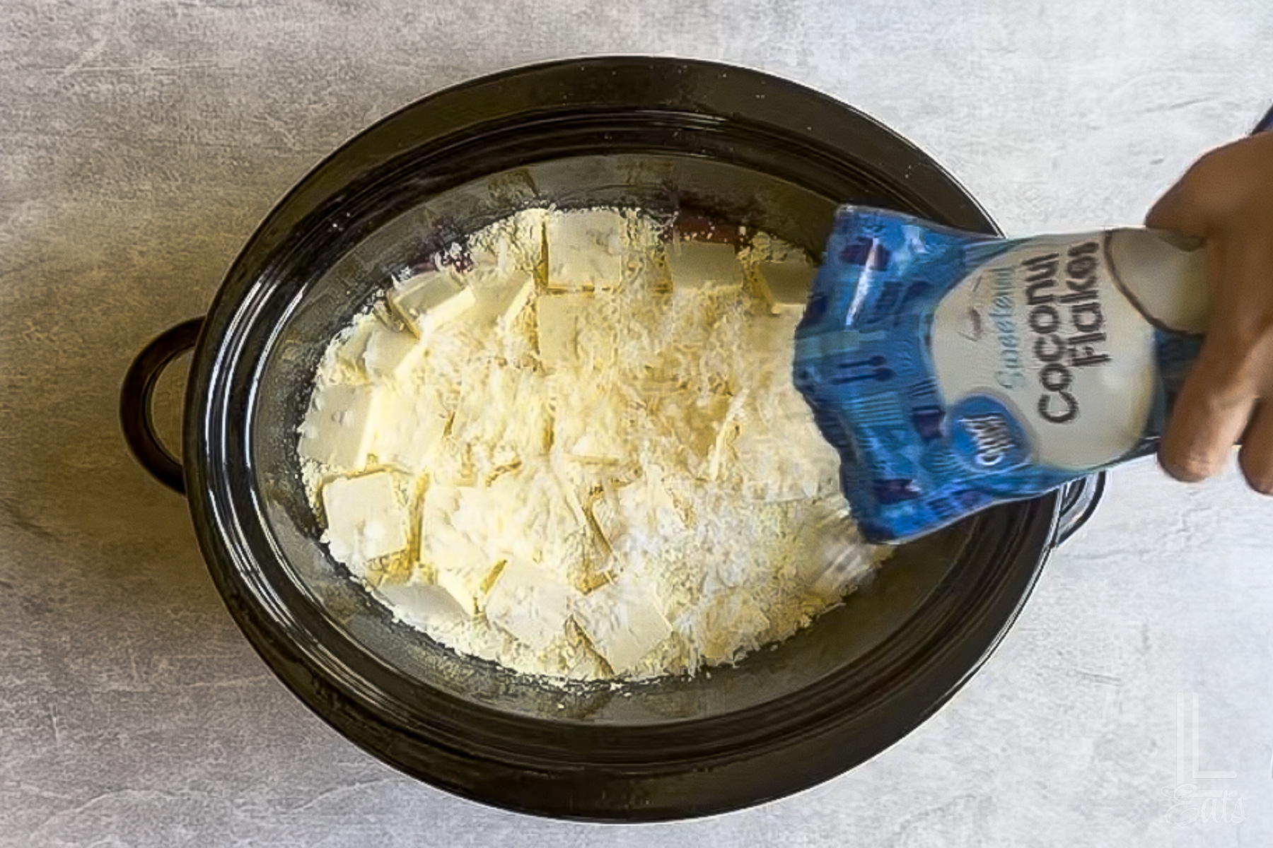 sprinkling sweetened coconut flakes over the dump cake mixture before cooking in the crock pot.