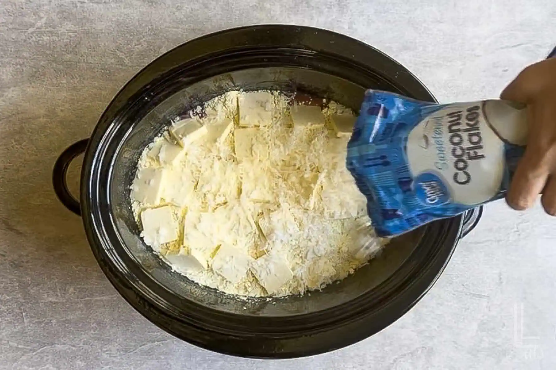 sprinkling sweetened coconut flakes over the dump cake mixture before cooking in the crock pot.