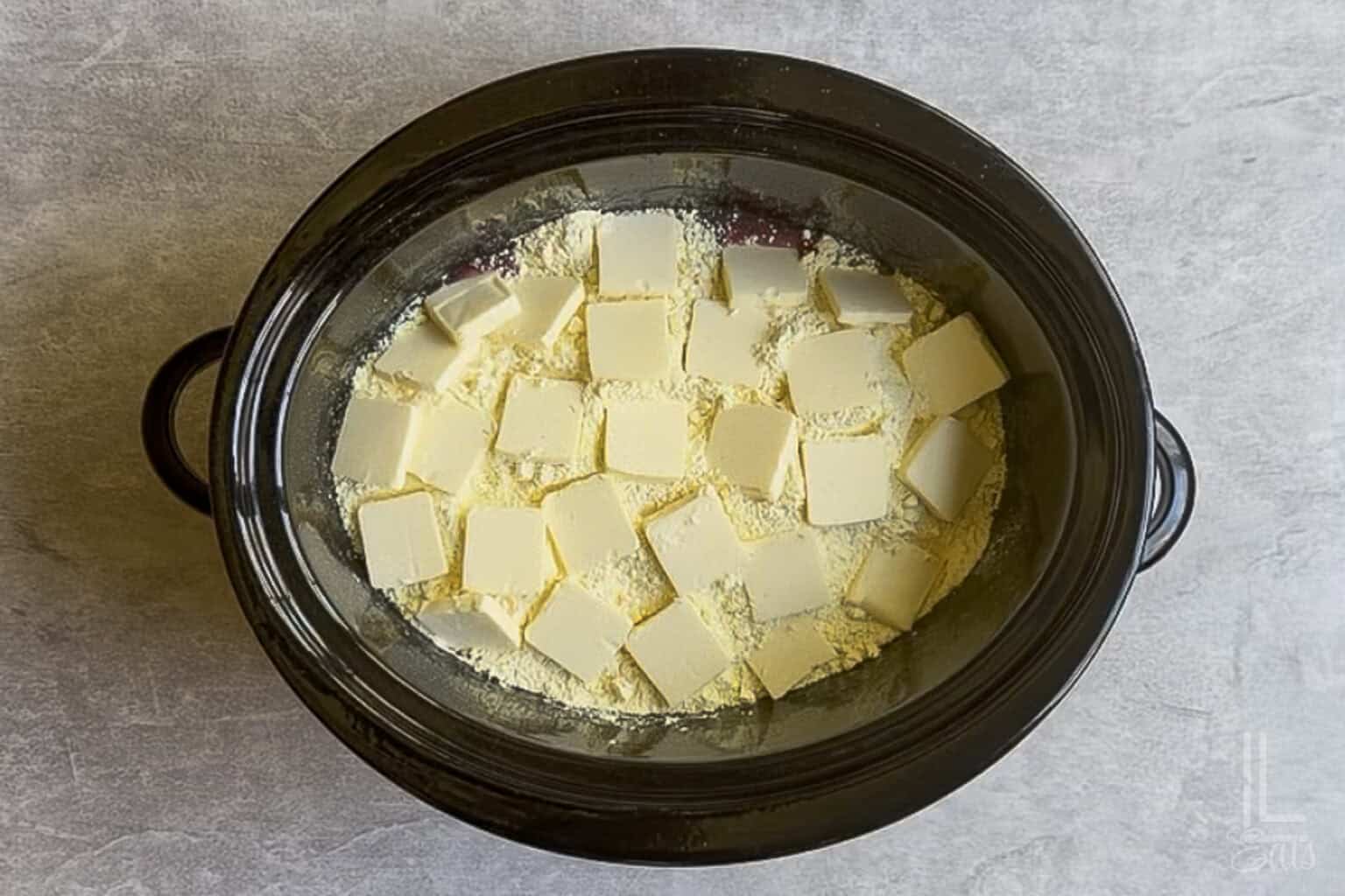 pats of butter placed over the cake mix in the crockpot.