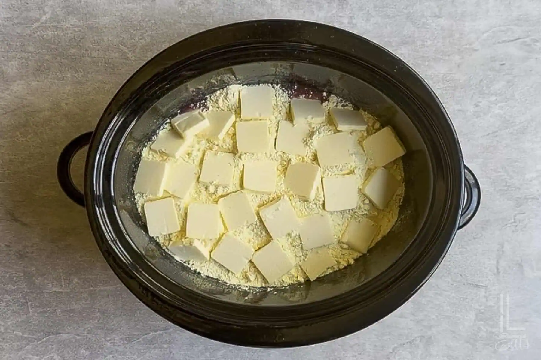 pats of butter placed over the cake mix in the crockpot.