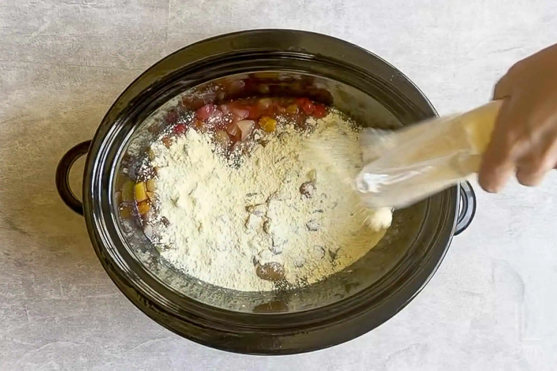 sprinkling lemon cake mix over the fruit mixture.