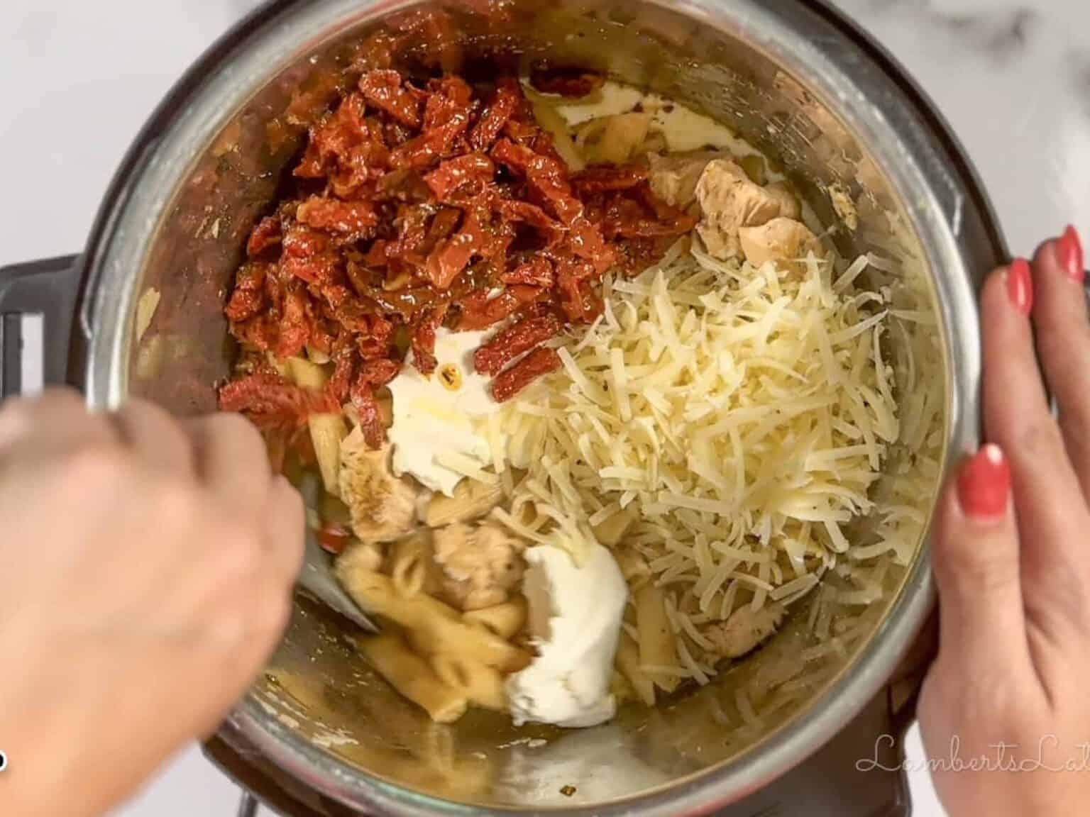 mixing parmesan cheese, cream cheese, sun-dried tomatoes in an instant pot.