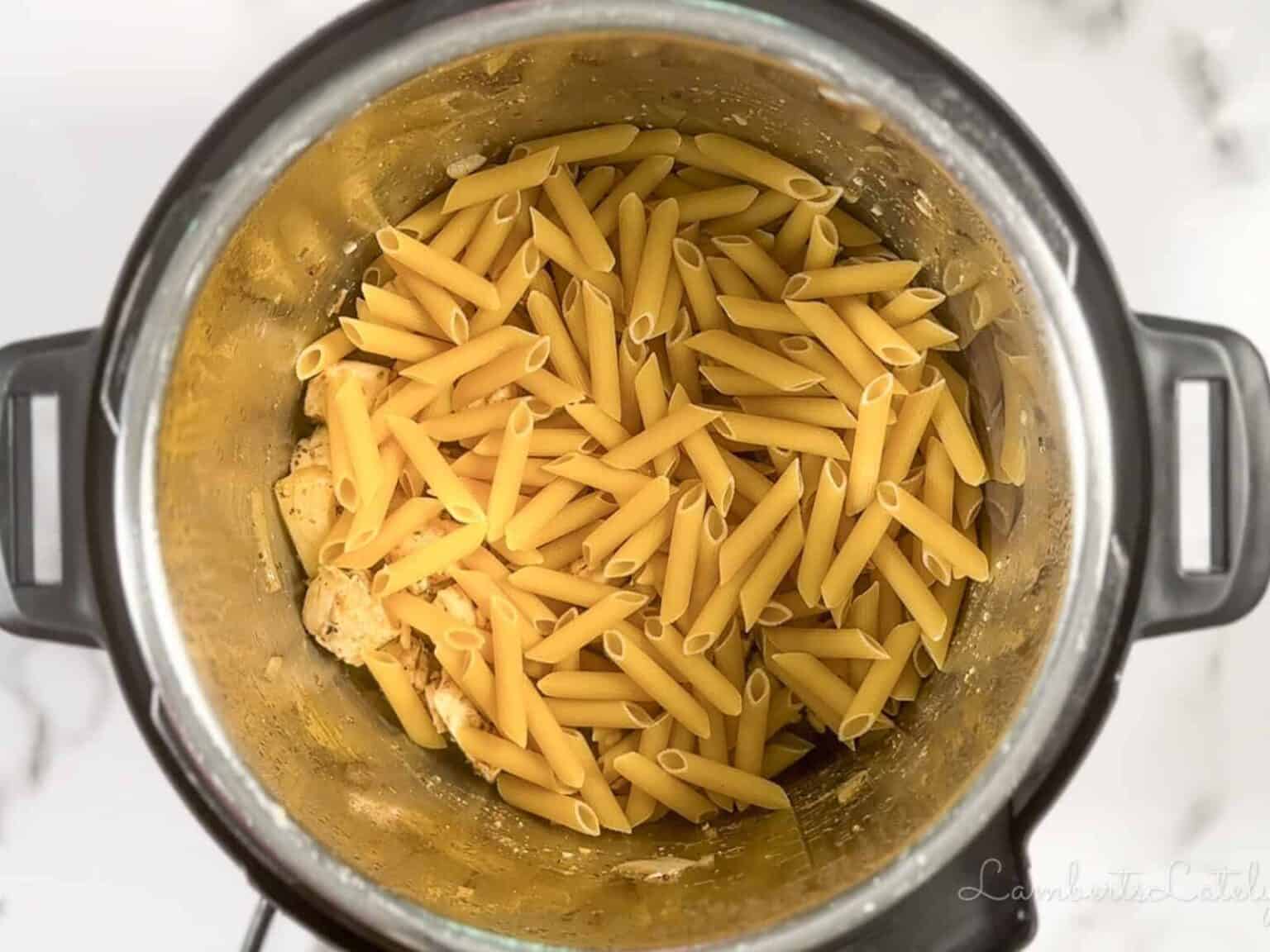 dry penne pasta and chicken broth in an Instant Pot before pressure cooking.