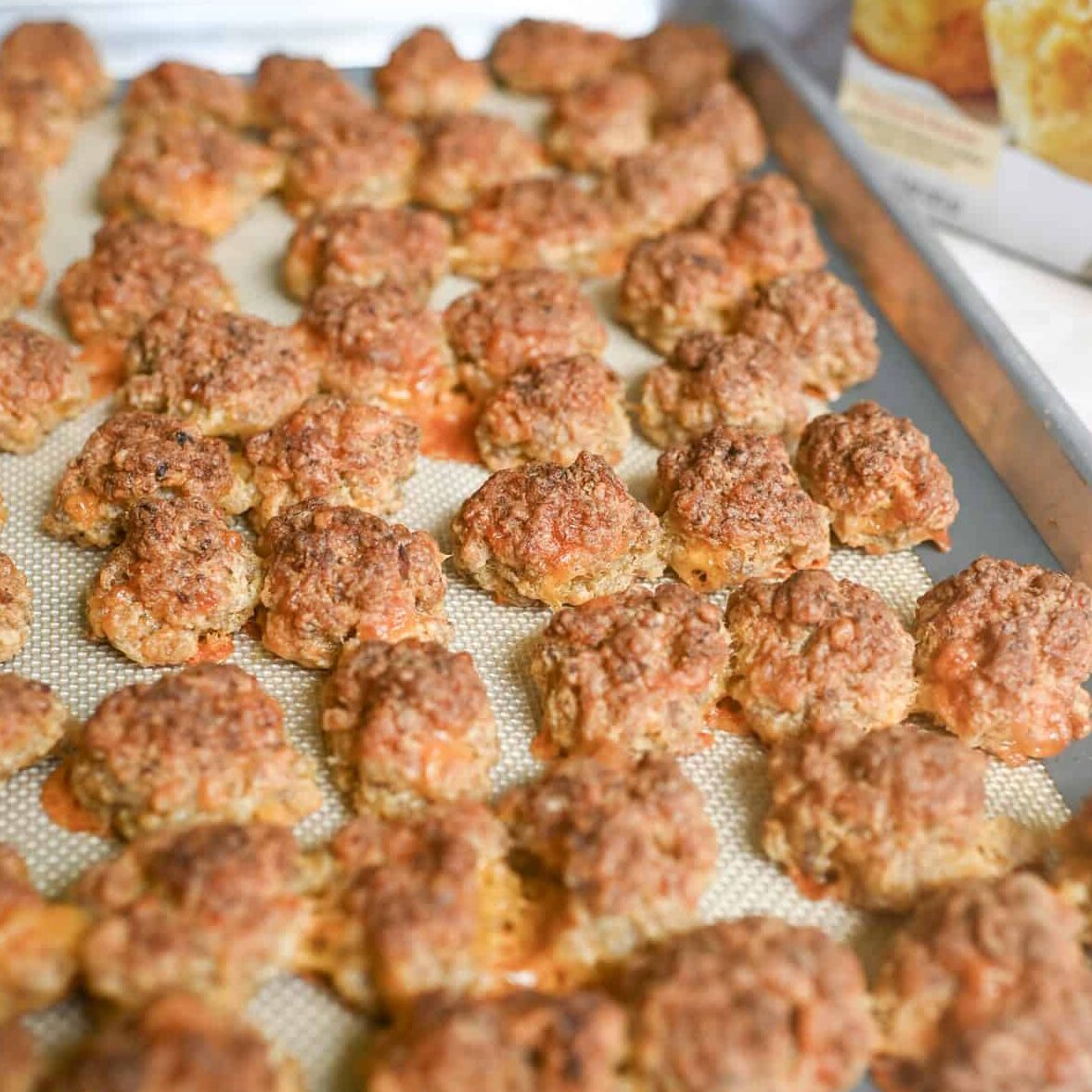 cooked red lobster sausage balls on a sheet pan.