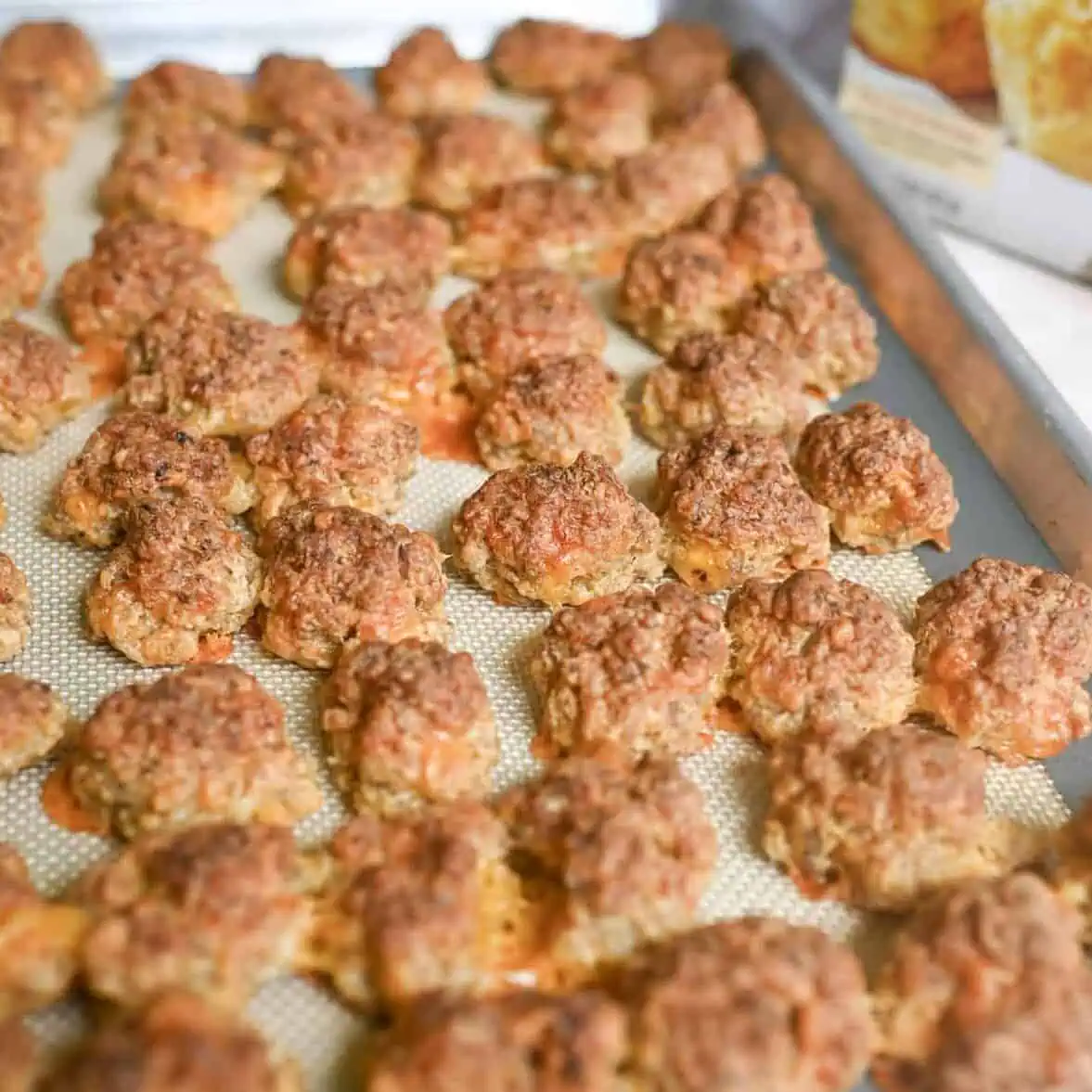 cooked red lobster sausage balls on a sheet pan.