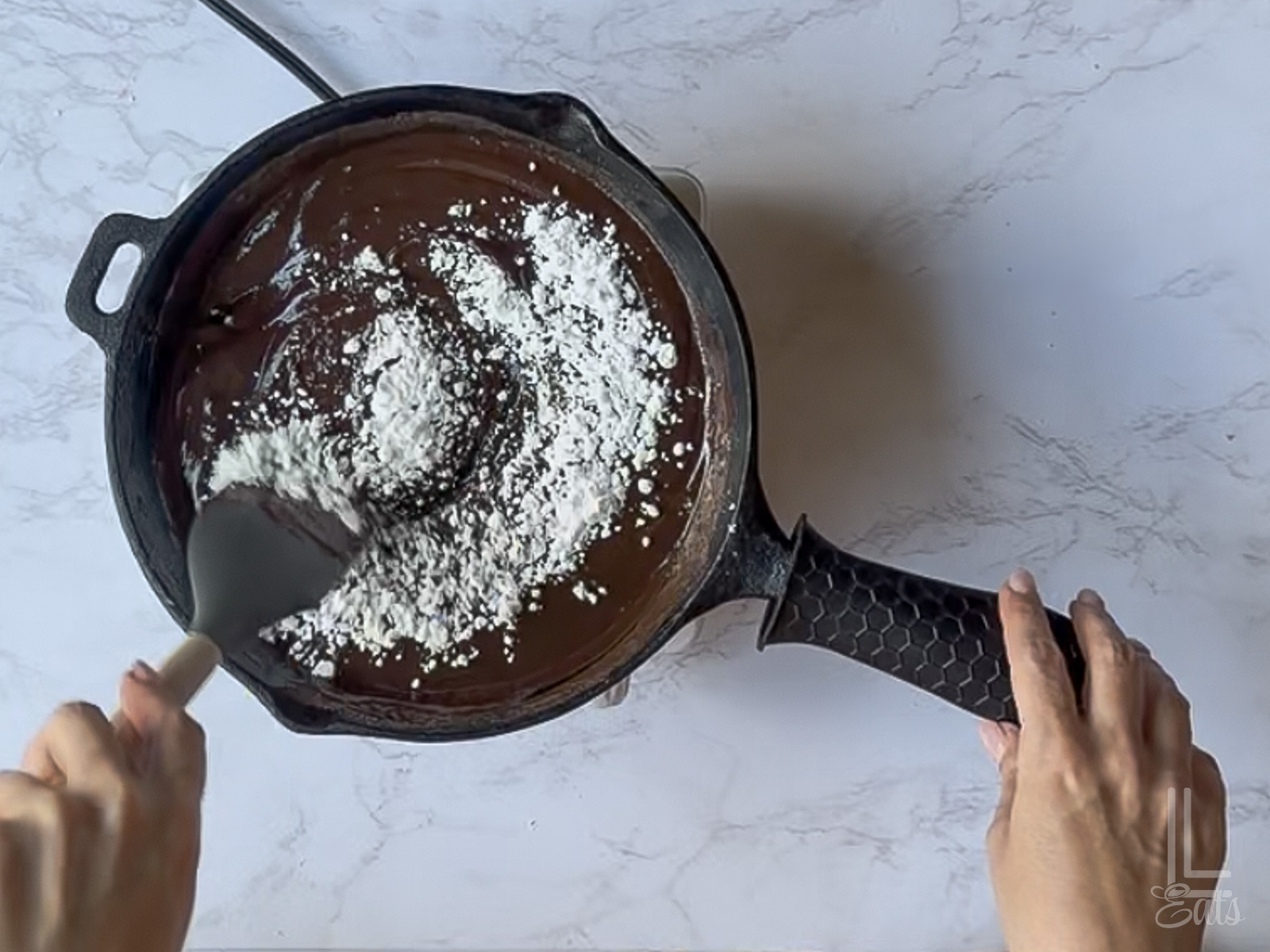 stirring powdered sugar into the chocolate mixture.