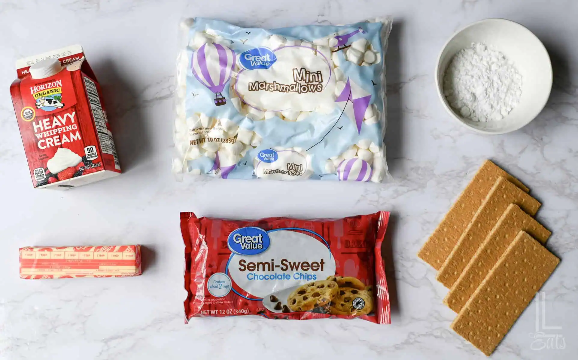 ingredients for smores dip, includes chocolate, marshmallows, and heavy cream.