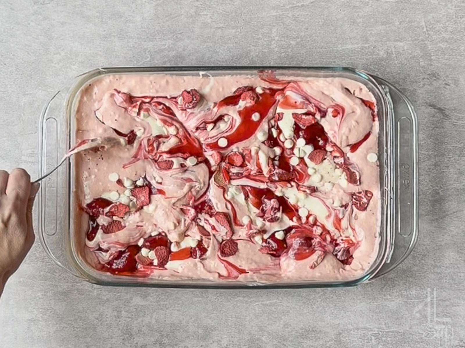 swirling the uncooked strawberry earthquake cake together.