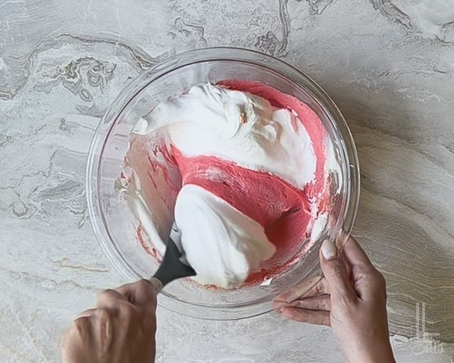 folding cool whip into jello mixture with a spatula.