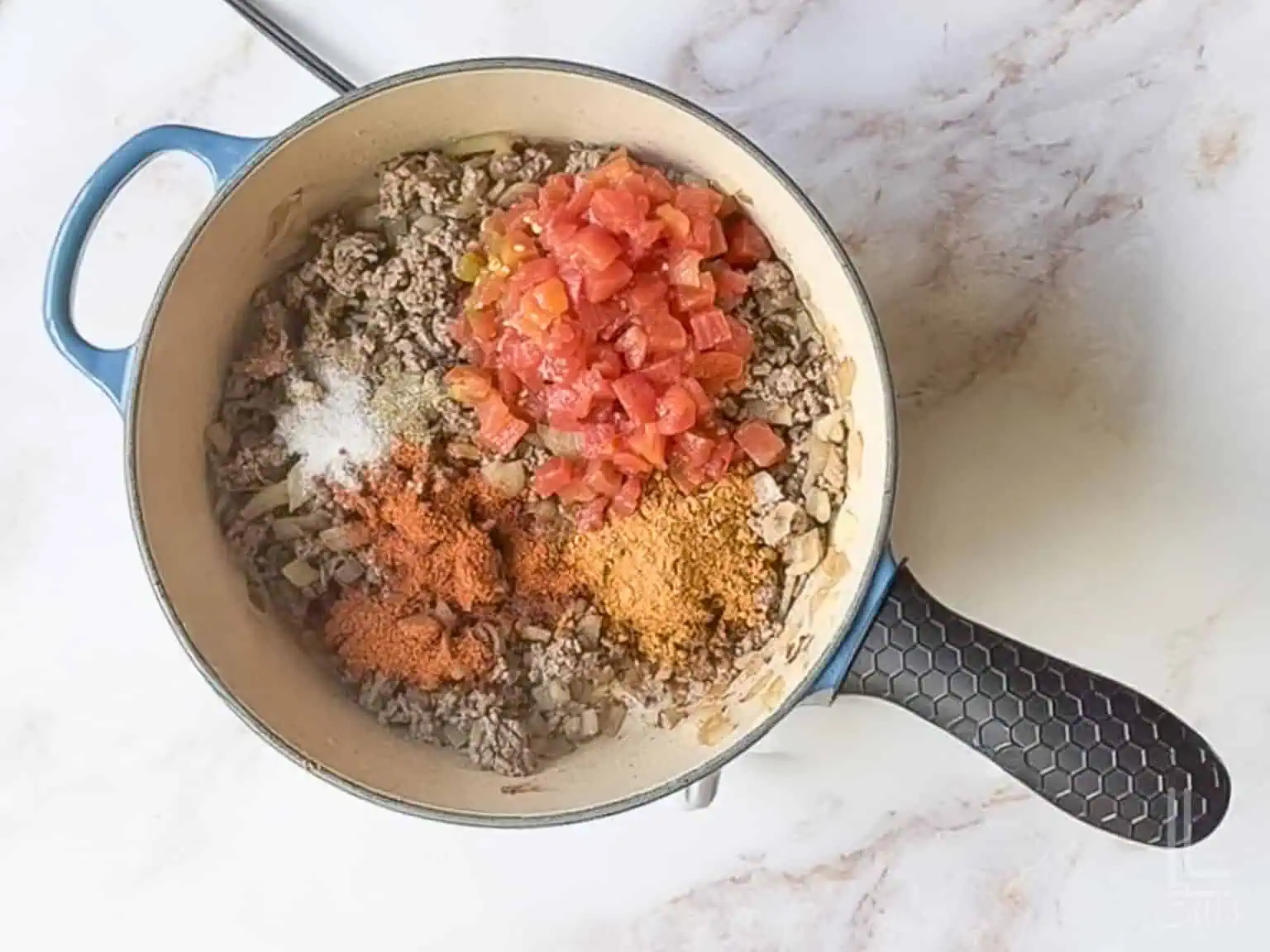 added rotel and spices to the ground beef mixture.