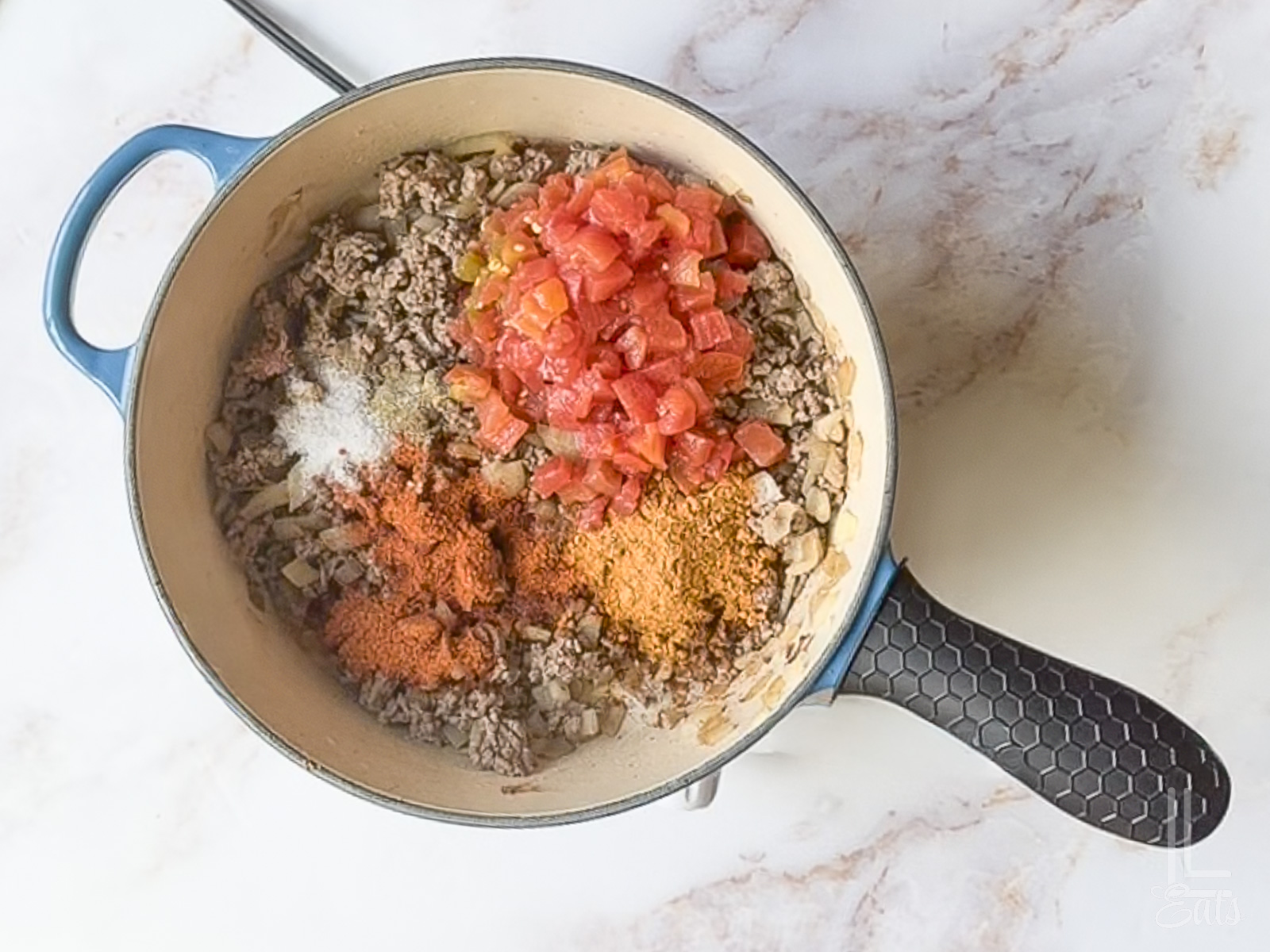 added rotel and spices to the ground beef mixture.