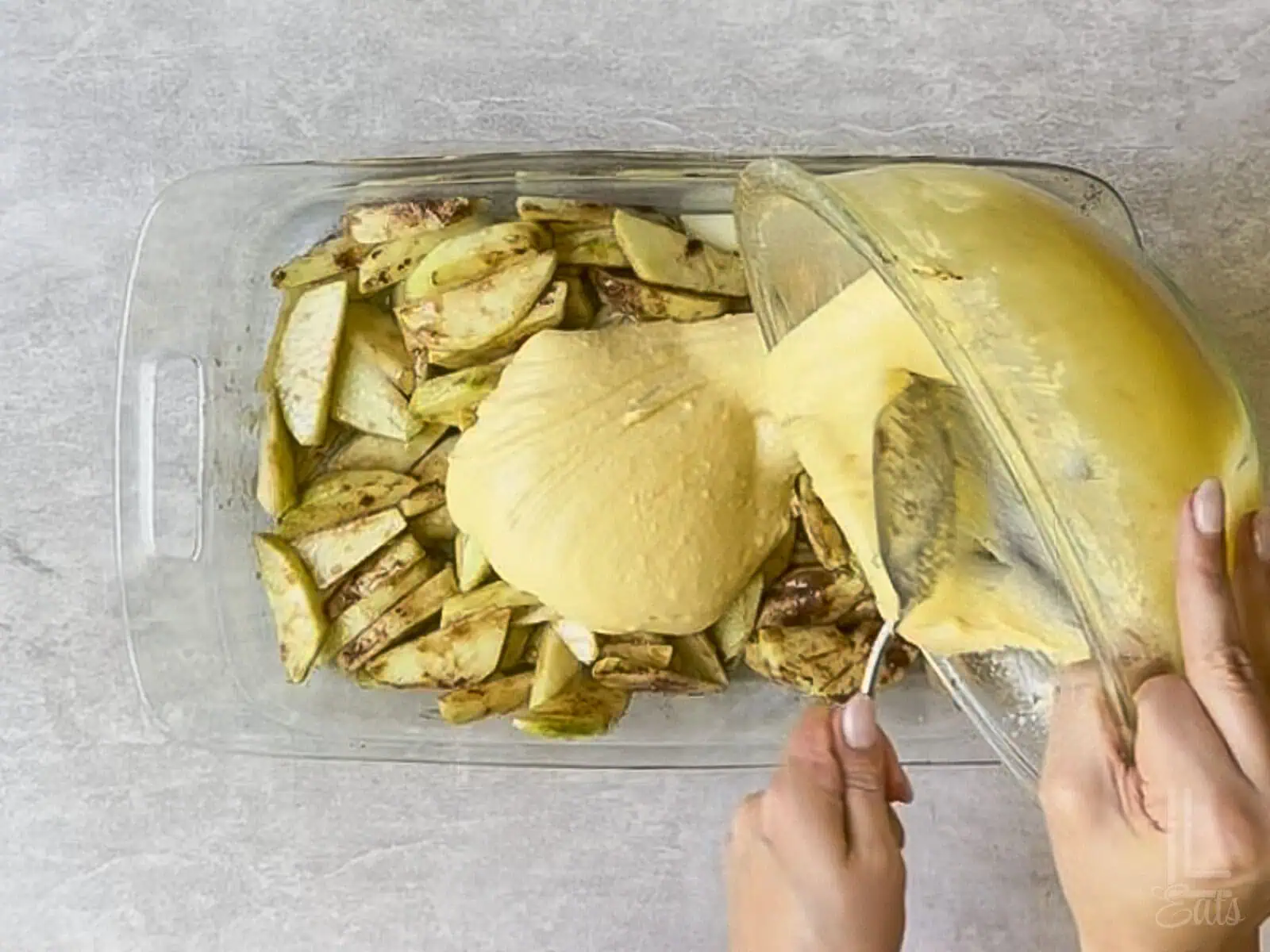 covering the apples with cake mix batter.