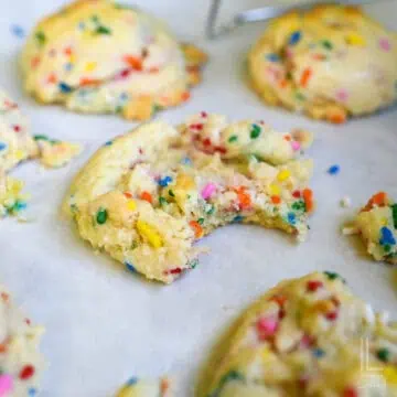 funfetti cake mix cookie with bite taken out.