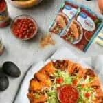Cheesy crescent roll taco ring with fresh toppings and salsa for a delicious meal.