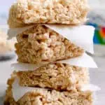 Stack of Rice Krispie Treats with marshmallow fluff on top.