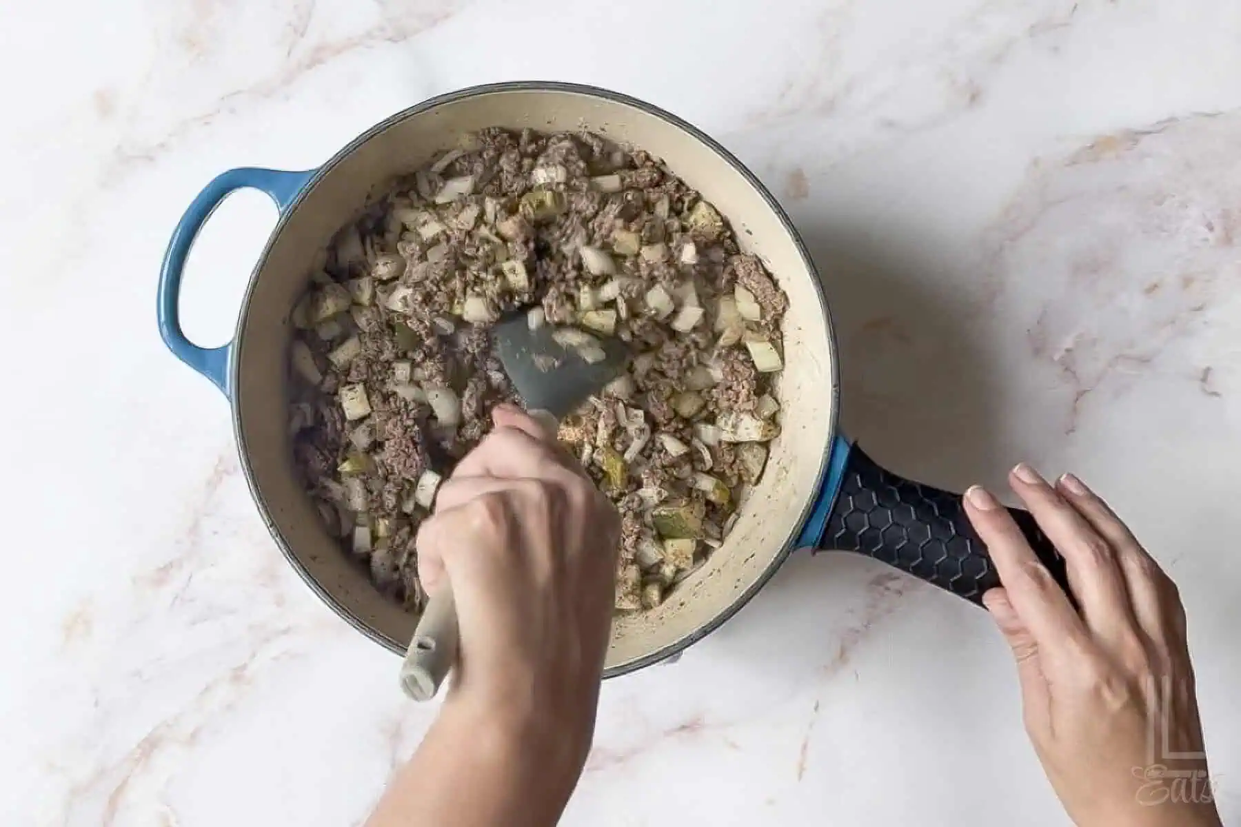 sauteeing ground beef, onion, and chopped pickles in a large skillet.